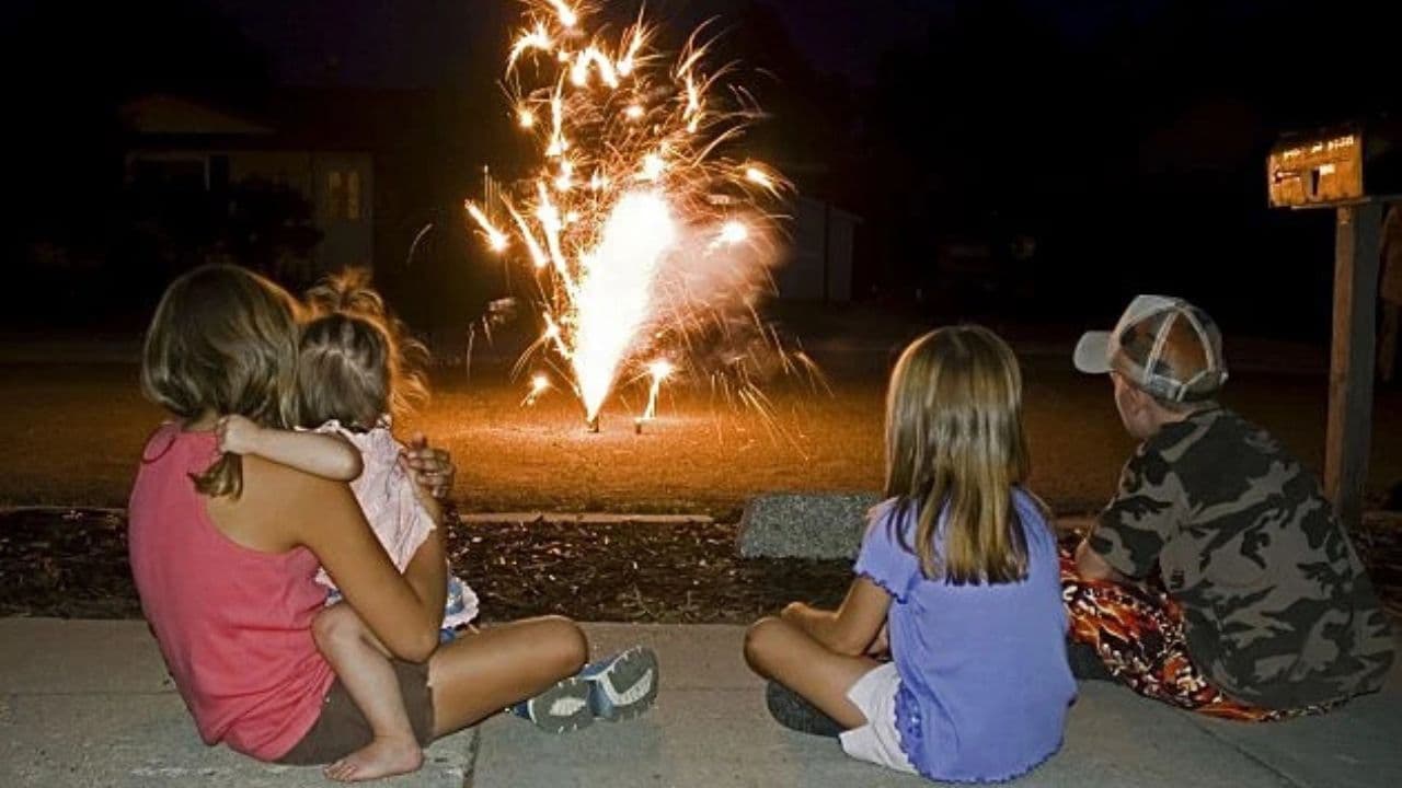Family sitting together watching Weaverville fireworks
